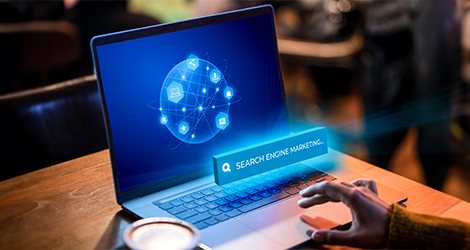Search engine marketing concept displayed on a laptop screen with a digital network graphic
